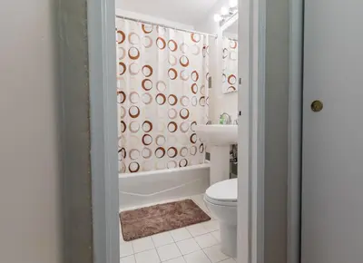 a bathroom with a toilet and a shower curtain at 2 Bed Apt Ideally located in UES of Manhattan in New York