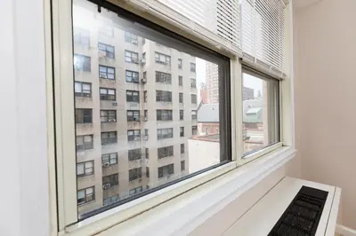 a window with a view of a building at 2 Bed Apt Ideally located in UES of Manhattan in New York