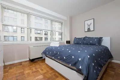 a bedroom with a bed and a window at 2 Bed Apt Ideally located in UES of Manhattan in New York