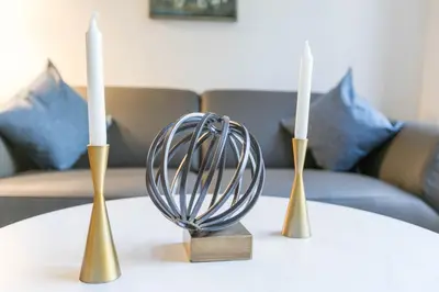 a table with two candles and a bowl on it at Fully Furnished 1BR in Murray Hills in New York