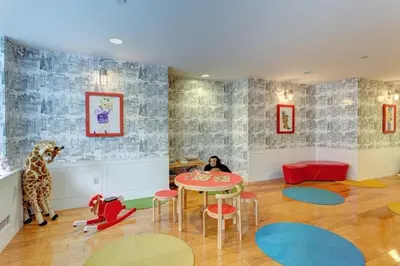 a room with a table and a giraffe and chairs at Fully Furnished 1BR in Murray Hills in New York