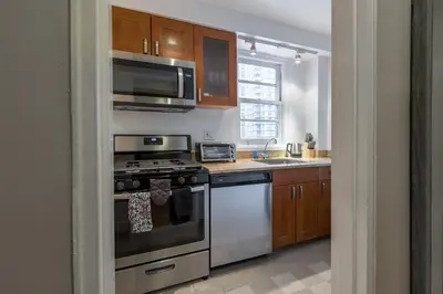 a kitchen with a stove and a microwave at Lovely Studio New York Apartment in New York
