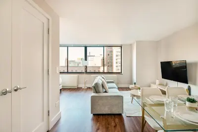 a living room with a couch and a table at Gorgeous Studio Apartment in New York