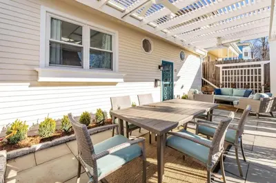 a patio with a wooden table and chairs at Cottage At Yale in New Haven