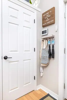 a room with a white door and a sign on the wall at Cottage At Yale in New Haven