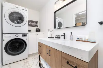 a laundry room with a washing machine and a sink at Cottage At Yale in New Haven
