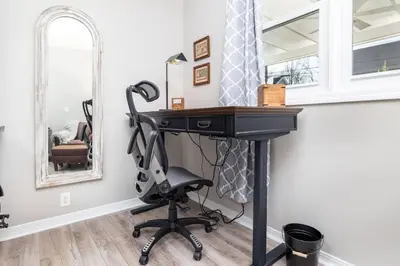 a desk in a room with a chair and a mirror at Cottage At Yale in New Haven