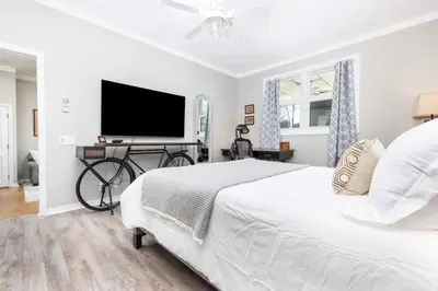 a bedroom with a bed and a flat screen tv at Cottage At Yale in New Haven