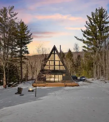 a house in the middle of a snow covered field at The Windham A in Windham
