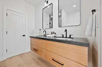 a bathroom with a sink and two mirrors at The Windham A in Windham