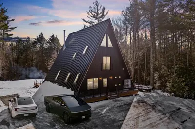 a house with a car parked in front of it at The Windham A in Windham