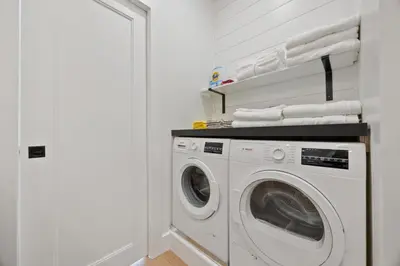 a white laundry room with a washing machine at The Windham A in Windham