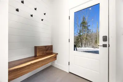 a white door in a house with a window at The Windham A in Windham