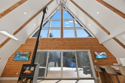 a room with a large window in a house at The Windham A in Windham