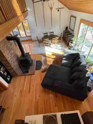 an aerial view of a living room with a black couch at Copake Lakes Hidden Treasure in Copake