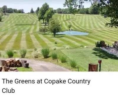 a view of a green field with a lake in it at Copake Lakes Hidden Treasure in Copake