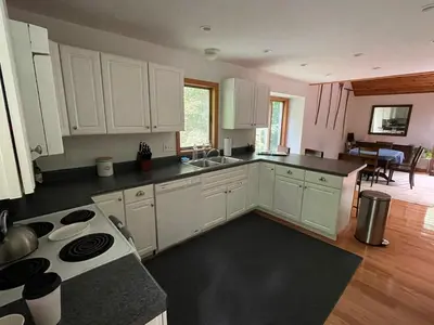 a kitchen with white cabinets and a stove top oven at Copake Lakes Hidden Treasure in Copake