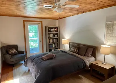 a bedroom with a bed and a ceiling fan at Copake Lakes Hidden Treasure in Copake
