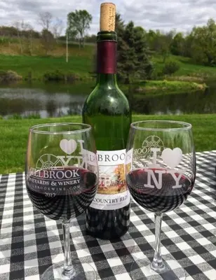a bottle of wine and two wine glasses on a table at Copake Lakes Hidden Treasure in Copake