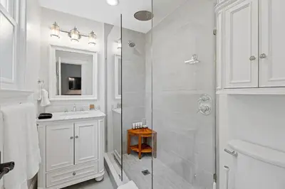a white bathroom with a shower and a sink at Red Cross Haven in New Haven