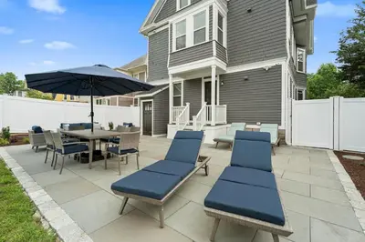 a patio with a table and chairs and an umbrella at Red Cross Haven in New Haven