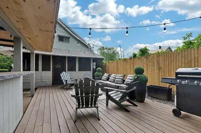 a patio with a couch and chairs on a deck at Charming Family Saratoga Home Walk to Track & Downtown in Saratoga Springs