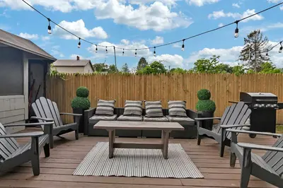 a patio with a table and chairs and a grill at Charming Family Saratoga Home Walk to Track & Downtown in Saratoga Springs