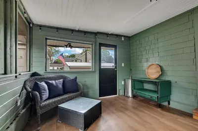 a porch with a couch and a table and a window at Charming Family Saratoga Home Walk to Track & Downtown in Saratoga Springs