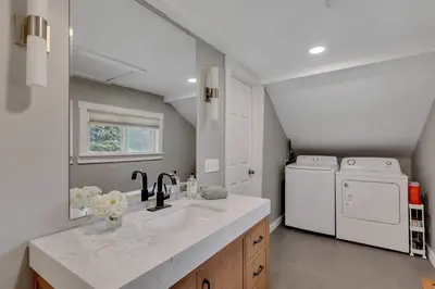 a kitchen with a sink and a washer and dryer at Charming Family Saratoga Home Walk to Track & Downtown in Saratoga Springs