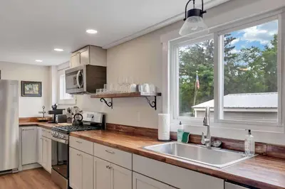 a kitchen with a sink and a window at Charming Family Saratoga Home Walk to Track & Downtown in Saratoga Springs