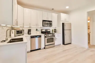 a kitchen with white cabinets and stainless steel appliances at Trailside Escape 2BR Views Fireplace & Balcony in Hunter