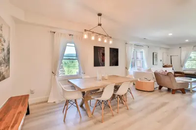a dining room and living room with a table and chairs at Trailside Escape 2BR Views Fireplace & Balcony in Hunter
