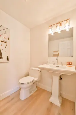 a white bathroom with a toilet and a sink at Trailside Escape 2BR Views Fireplace & Balcony in Hunter