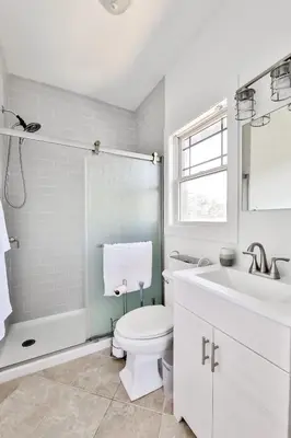 a white bathroom with a toilet and a sink at Trailside Escape 2BR Views Fireplace & Balcony in Hunter