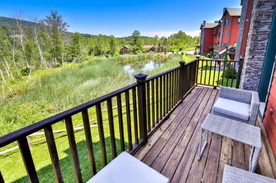 a deck with two chairs and a view of a river at Trailside Escape 2BR Views Fireplace & Balcony in Hunter