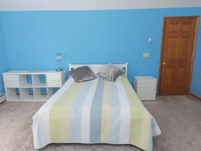 a bedroom with a bed with two pillows on it at Spacious House with a Pool in Glen Spey