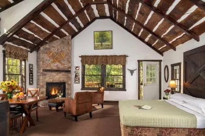a bedroom with a bed and a fireplace at Inn at Lake Joseph in Forestburgh