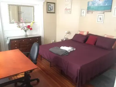 a bedroom with a purple bed and a table at Whitney Wonder 2nd and 3rd floor in Hartford