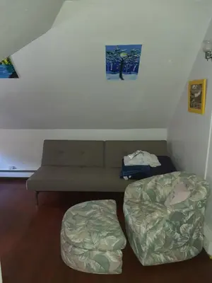 a living room with a couch and a chair at Whitney Wonder 2nd and 3rd floor in Hartford