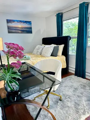 a living room with a bed and a glass table at BP STAYS - Hotel-Style, No Host, Professionally Managed ID252 in Jersey City