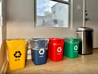 four trash cans are lined up in a room at BP STAYS - Hotel-Style, No Host, Professionally Managed ID252 in Jersey City