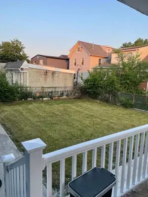a balcony with a white fence and a yard at The Vault in Hillside