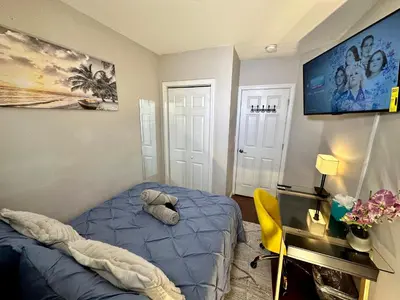 a bedroom with a blue bed and a yellow chair at Hotel-Style, No Host, Professionally Managed ID267 in Jersey City