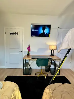 a desk in a room with a computer on the wall at BP STAYS - Hotel-Style, No Host, Professionally Managed ID280 in Jersey City