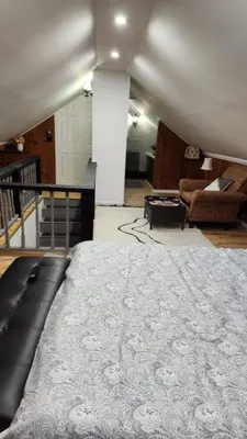 a bedroom with a large bed and a living room at Charming 3 bedroom 2 bath home in Bloomfield with wishing well in Bloomfield