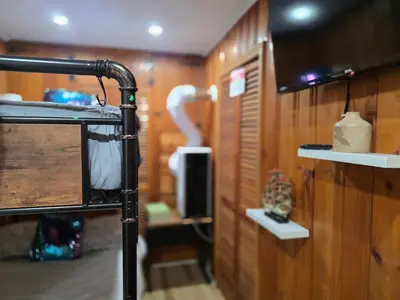 a room with a room with a tv and a wall at Charming 3 bedroom 2 bath home in Bloomfield with wishing well in Bloomfield