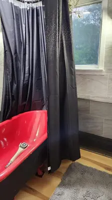 a red bath tub sitting next to a black curtain at Charming 3 bedroom 2 bath home in Bloomfield with wishing well in Bloomfield