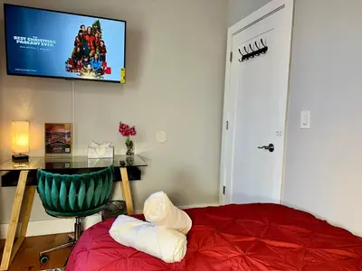 a bedroom with a bed and a desk and a tv at BP STAYS - Hotel-Style, No Host, Professionally Managed ID265 in Jersey City