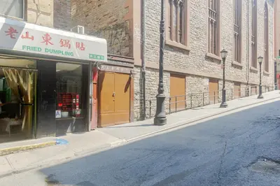 an empty street with a store on the side of a building at Blueground Chinatown washer nr City Hall NYC-1871 in New York