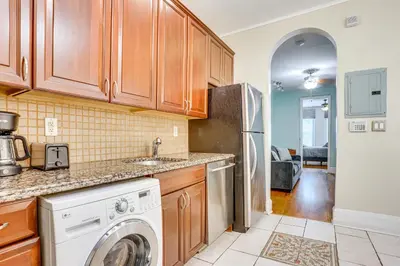 a kitchen with a washer and dryer at Walk to Washington St Hoboken Apt with Balcony! in Hoboken